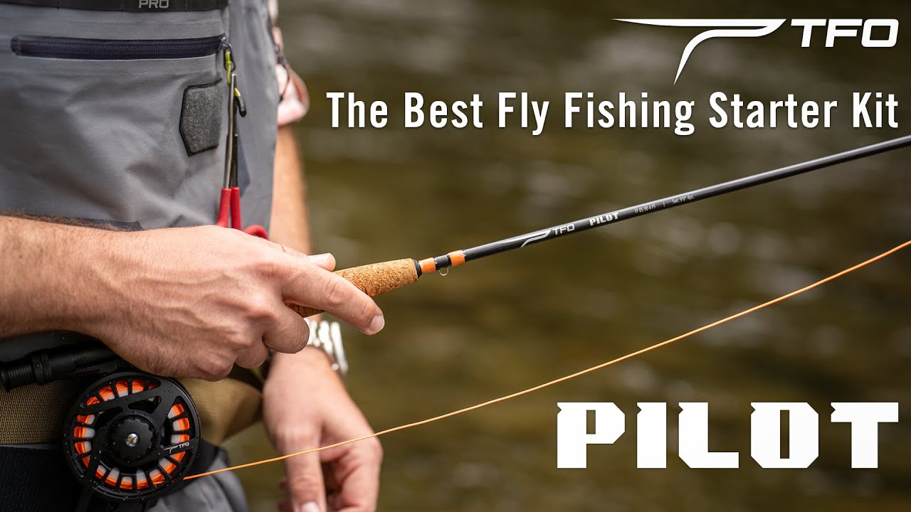 Angler holding a TFO Pilot fly rod and reel beside a stream, showing the rod handle, line, and starter kit setup.