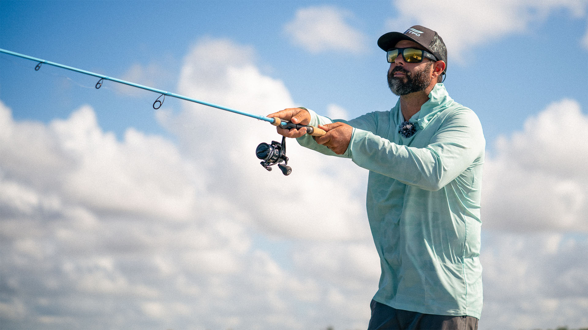 Angler casting a TFO IntraCoastal spinning rod during fall inshore fishing