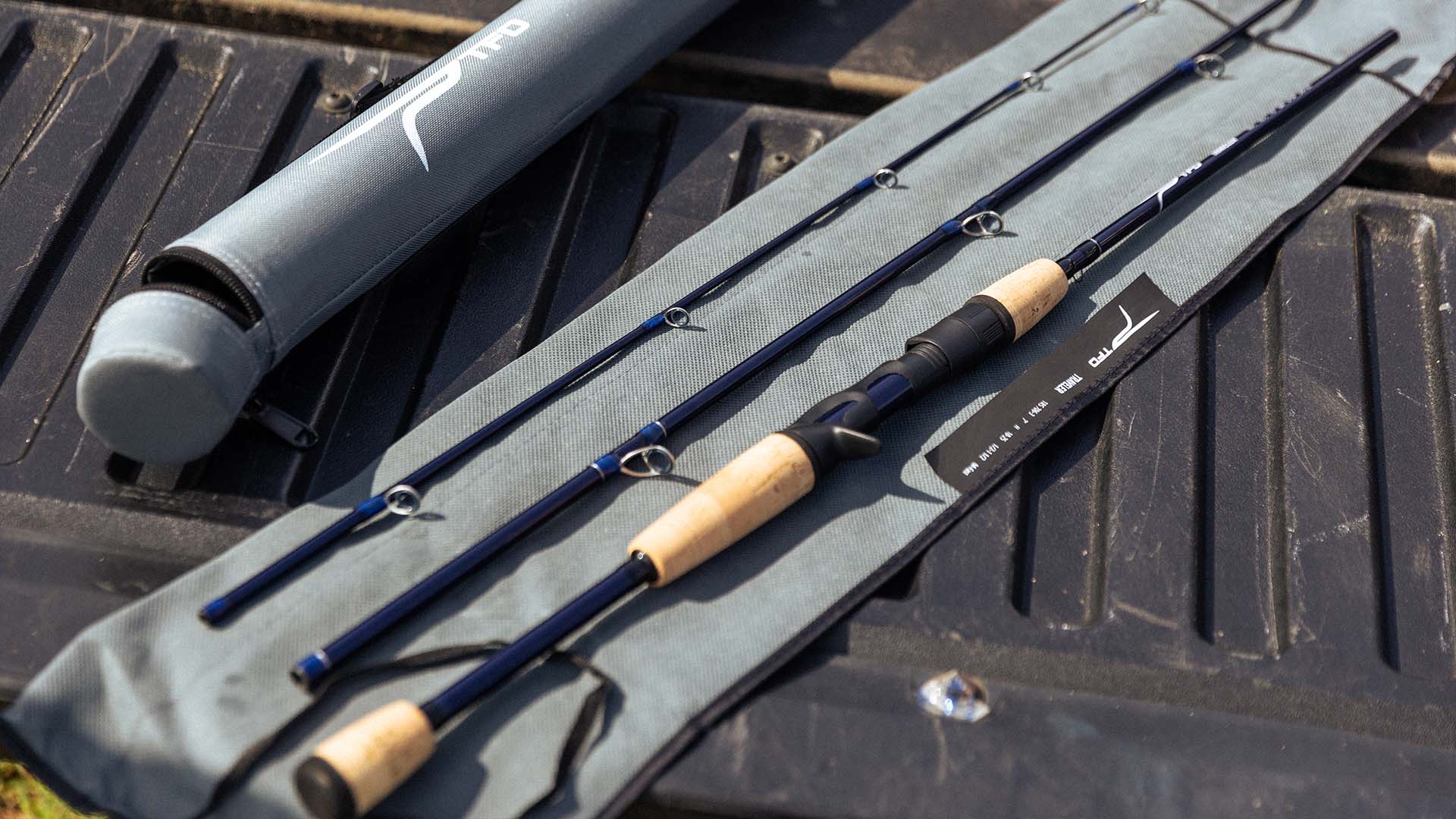 Disassembled TFO Traveler Series three piece spinning rod laid out on its protective sleeve on a truck tailgate, with its matching travel tube beside it.
