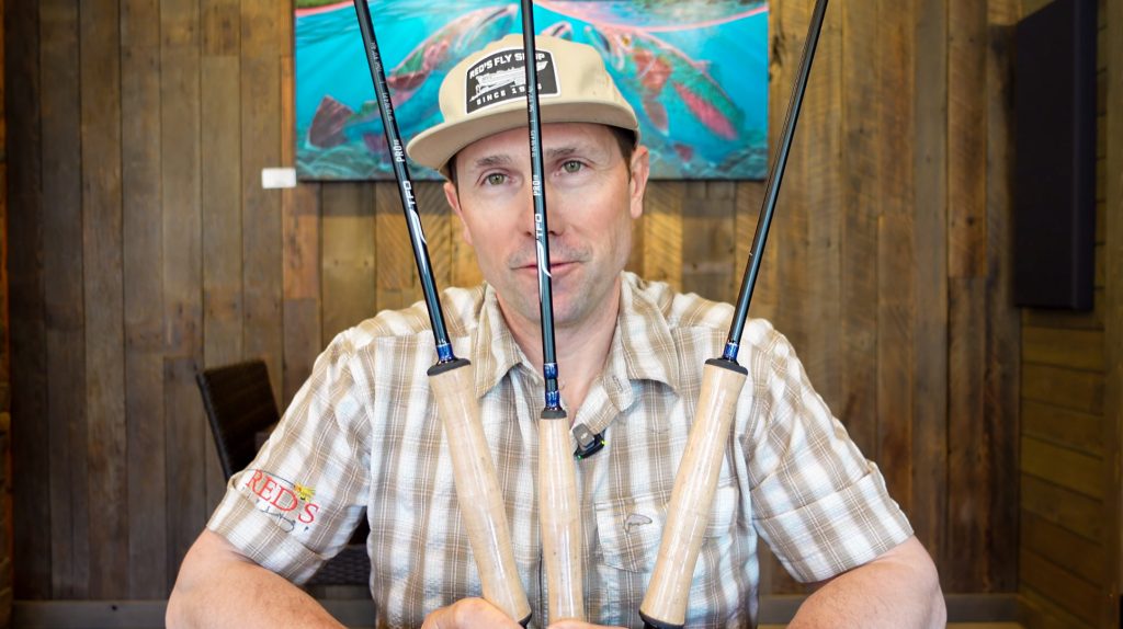 Joe from Red's Fly Shop holding TFO Pro III fly rods in 5 weight, 8 weight, and 10 weight during a staff review of the Temple Fork Outfitters Pro III series.