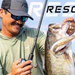 Bassmaster Elite pro Chris Zaldain lifting a big largemouth bass caught on a swimbait with a TFO Resolve casting rod